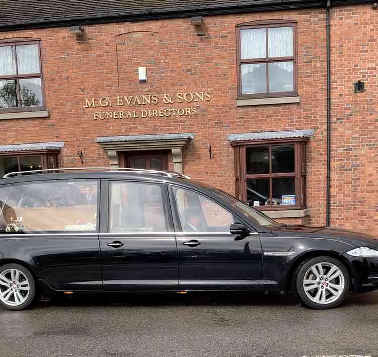 Moving on: The cortege leaves the funeral directors