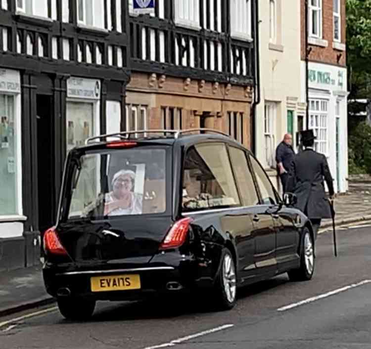 Smiling down on us: The picture of Jean Fulleylove at the back of the hearse