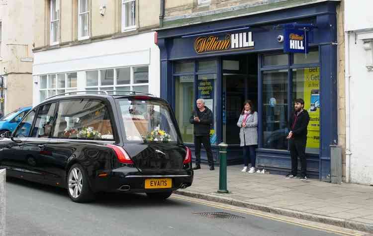 Outside 'second favourite': The hearse passes William Hill bookmakers