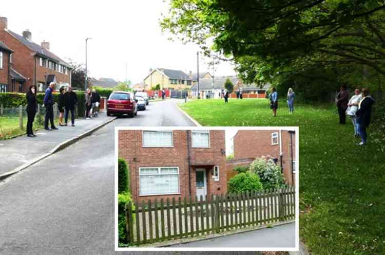 Home once more: Neighbours wait for the cortege outside his Princess Road home