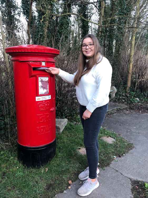 Millfield student Olivia Gray posting a letter for a local care home resident