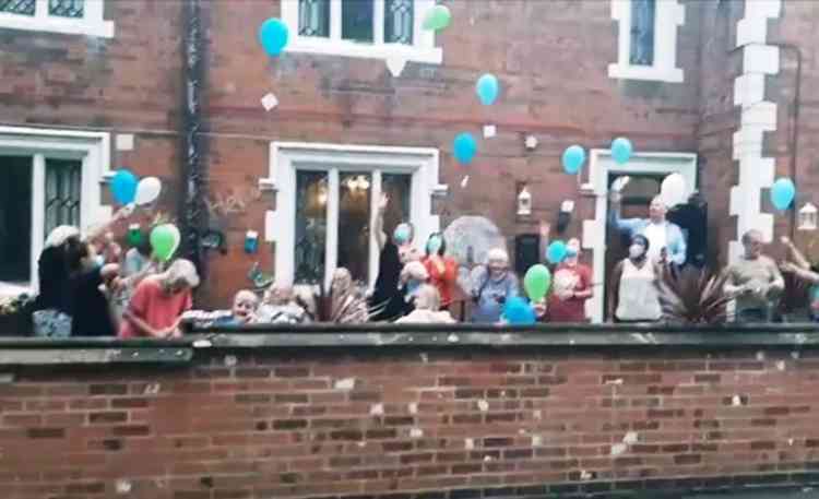 Clapping for their hero: Outside Merevale House last night