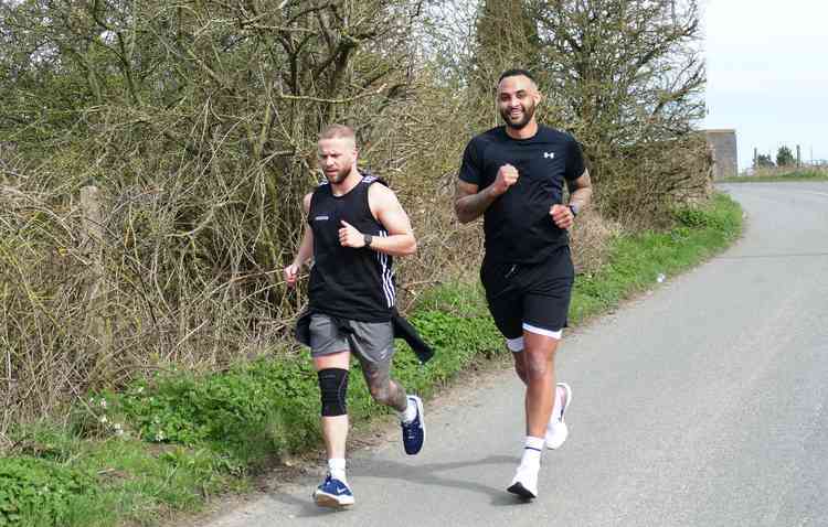 Keep on running: Joe Obi, right, and Adam Davies out on their daily exercise . . . Picture by Nick Hudson