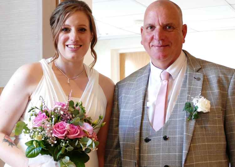 All smiles: Leanne and Dave Tolley enter the reception venue