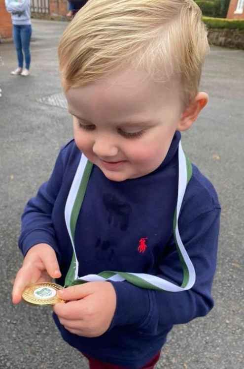 Henry admires dad Sam's medal