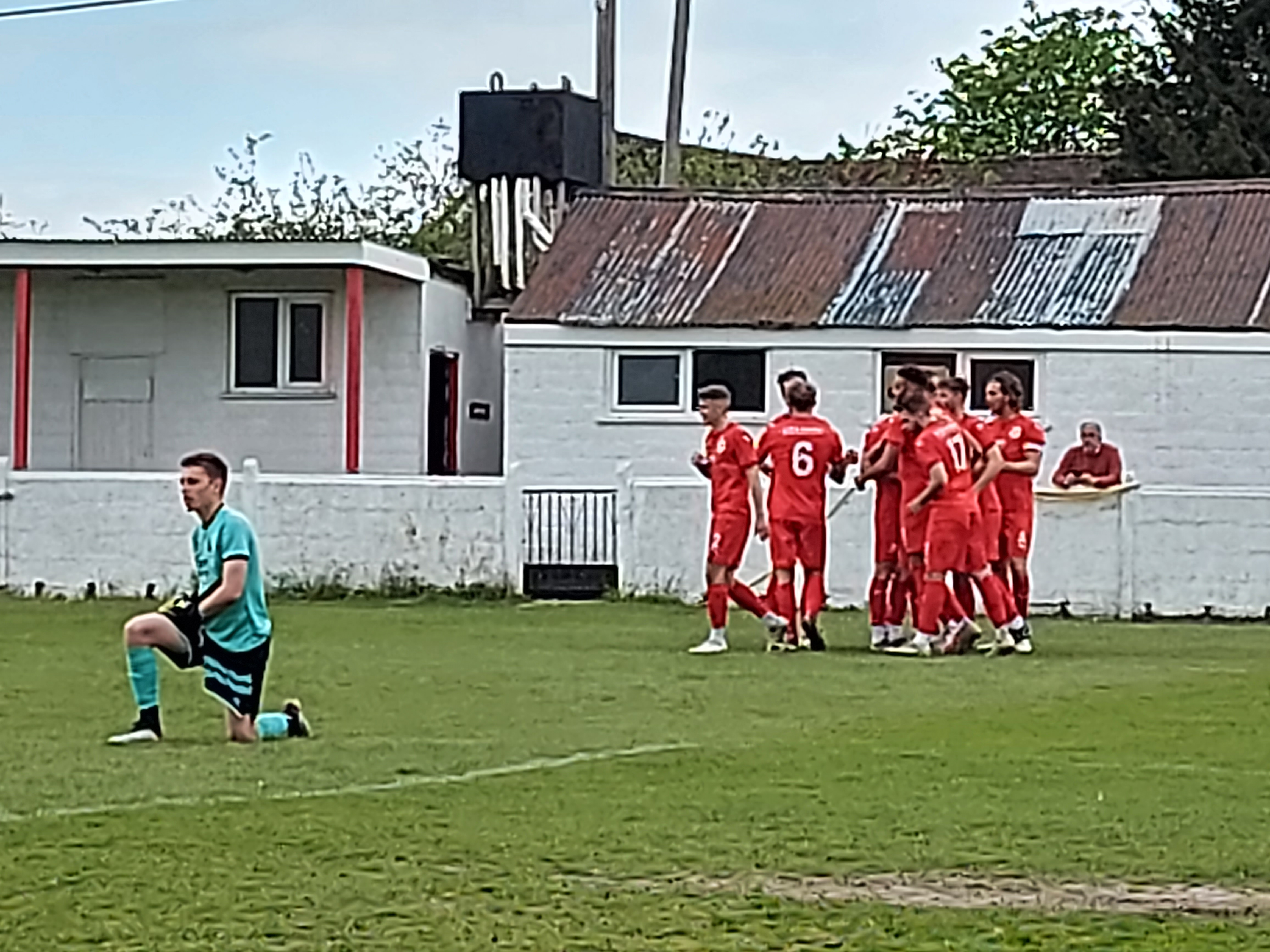 Frome celebrate their first goal against Paulton while Sainsbury looks downcast