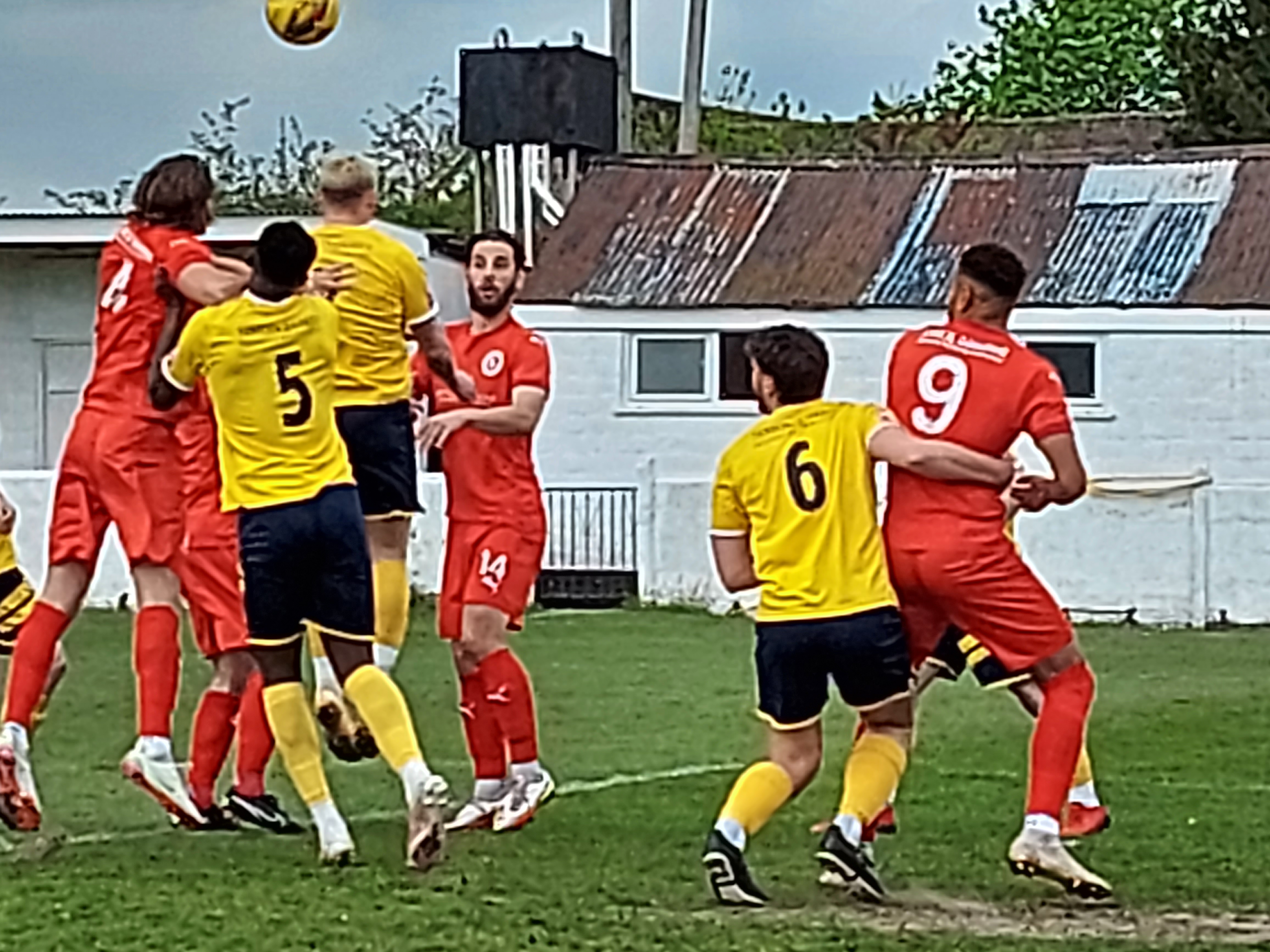 Kane is given a 'friendly' hug from the Paulton Rovers crew