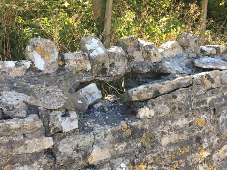 Damage to the stone wall around the church