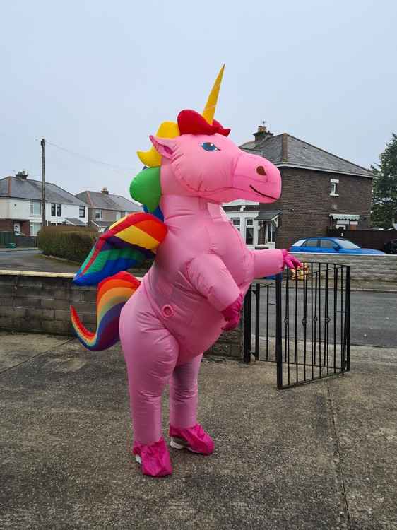 Genine modelling the big pink unicorn suit