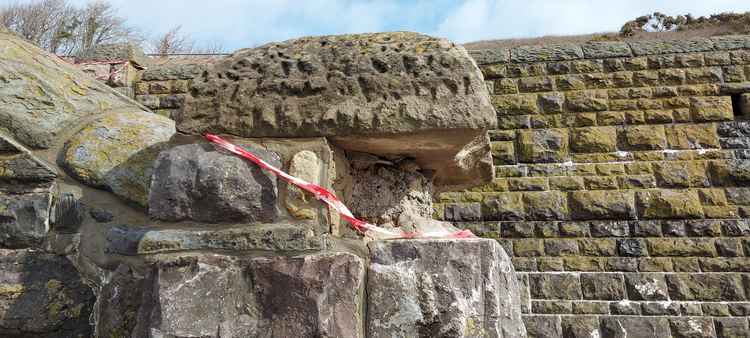 The damage to the stone steps wall