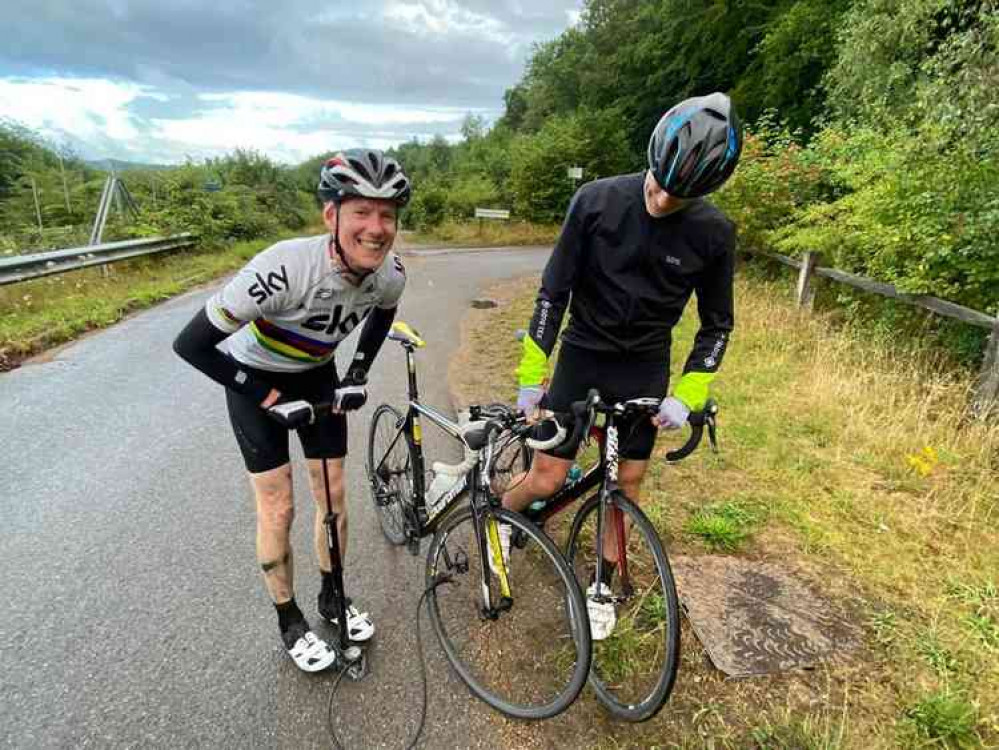 Dealing with one of six punctures the duo had to cope with on the day.