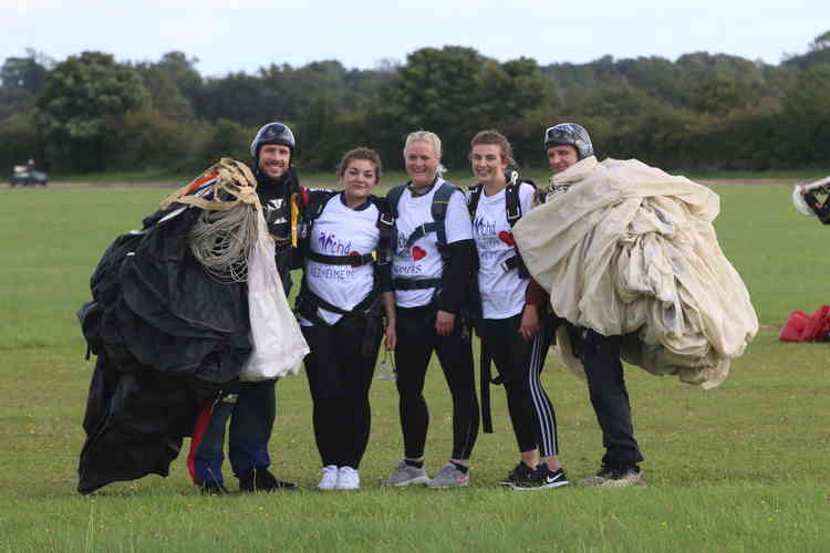 Emma Packer, Emma Leahy and Emily Reynolds with instructors after their skydive.