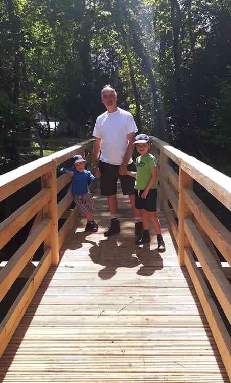 Richard with the couple's sons Sam and Josh on the bridge.