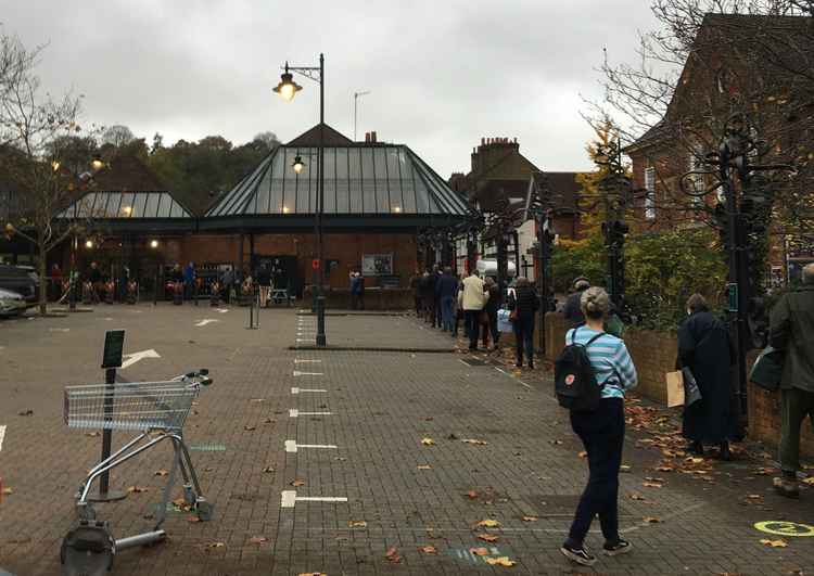 Shoppers queue to get into Waitrose on Sunday morning.