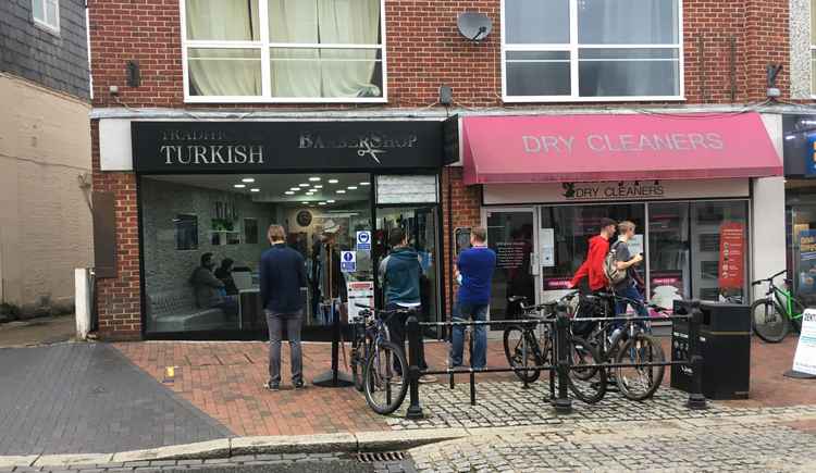 Queuing to get into the barber's.