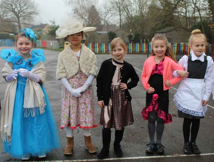 A group of young ladies, dressed in their best finery for the First Class lounge.