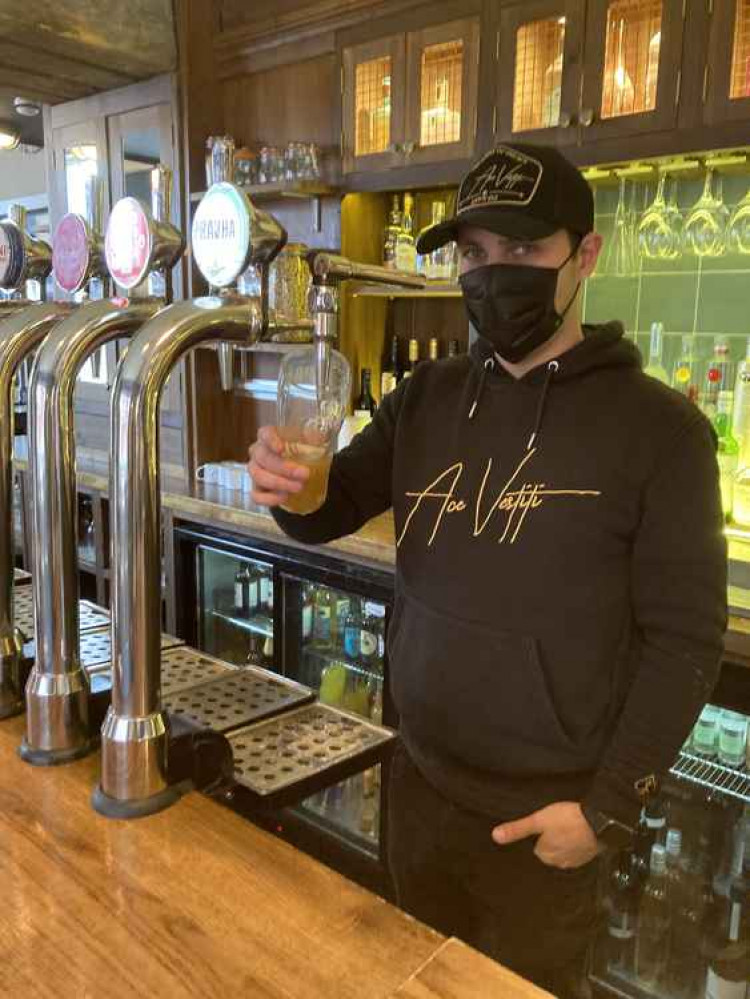 Charlie Neill-Hall pulls the first pint at The Red Lion.