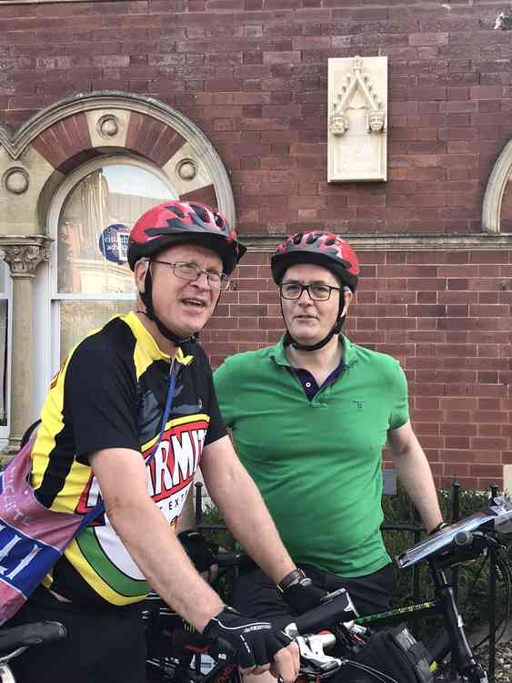 Two of the Cyclists in Front of the Queen Eleanor Memorial Stone at Grantham Civic Centre