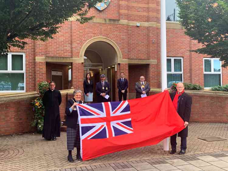 Pictured are Coun Smith and Capt Sail holding the flag, with (left to right) Father Cradduck, SKDC Chief Executive Karen Bradford, Armed Forces Champion Coun Dean Ward, SKDC Leader Coun Kelham Cooke and Grantham Mayor Coun Adam Stokes in attendance.