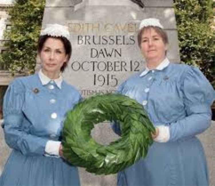 Two chosen nurses laying a wreath at Edith Cavell's statue in London last year