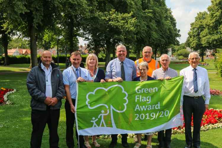 Steve Frisby, second from left, and members of the Wyndham Park team with the Green Flag award for 2019/20. Credit: SKDC