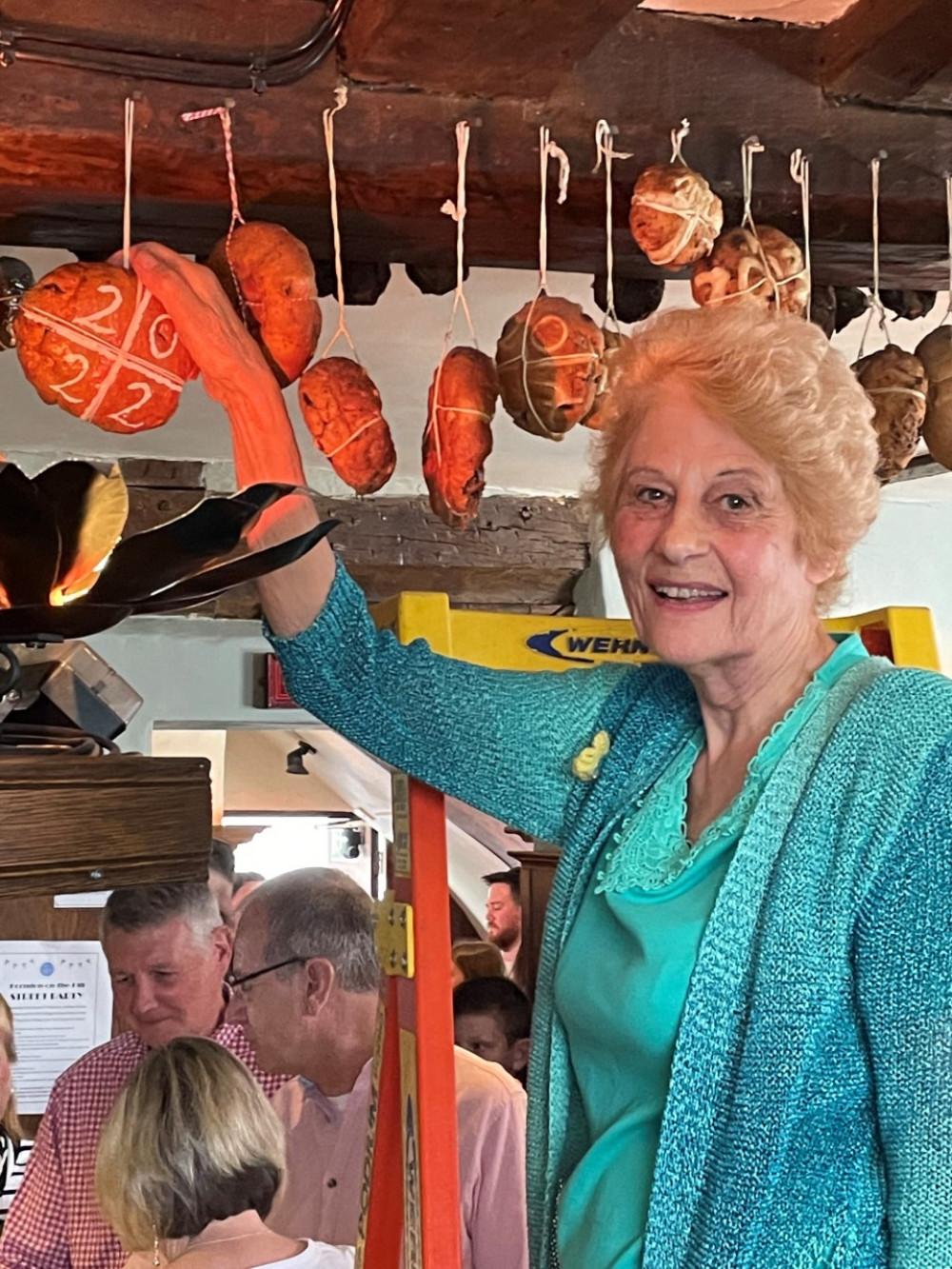 Judy Rood is picture hanging the 2022 hot cross bun in The Bell Inn at Horndon on the Hill.  