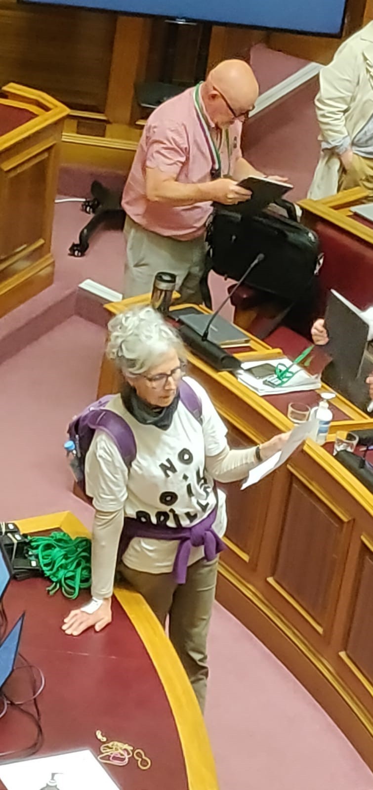 Annie Webster, wearing a ‘No oil drilling’ t-shirt, tries to read her statement despite heckling from Conservative councillors