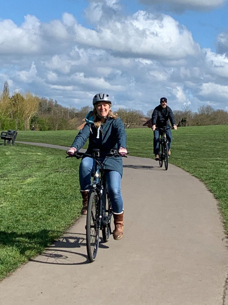 Two smiling participants on e-bikes at the free trial in Frome on 1 April 2022