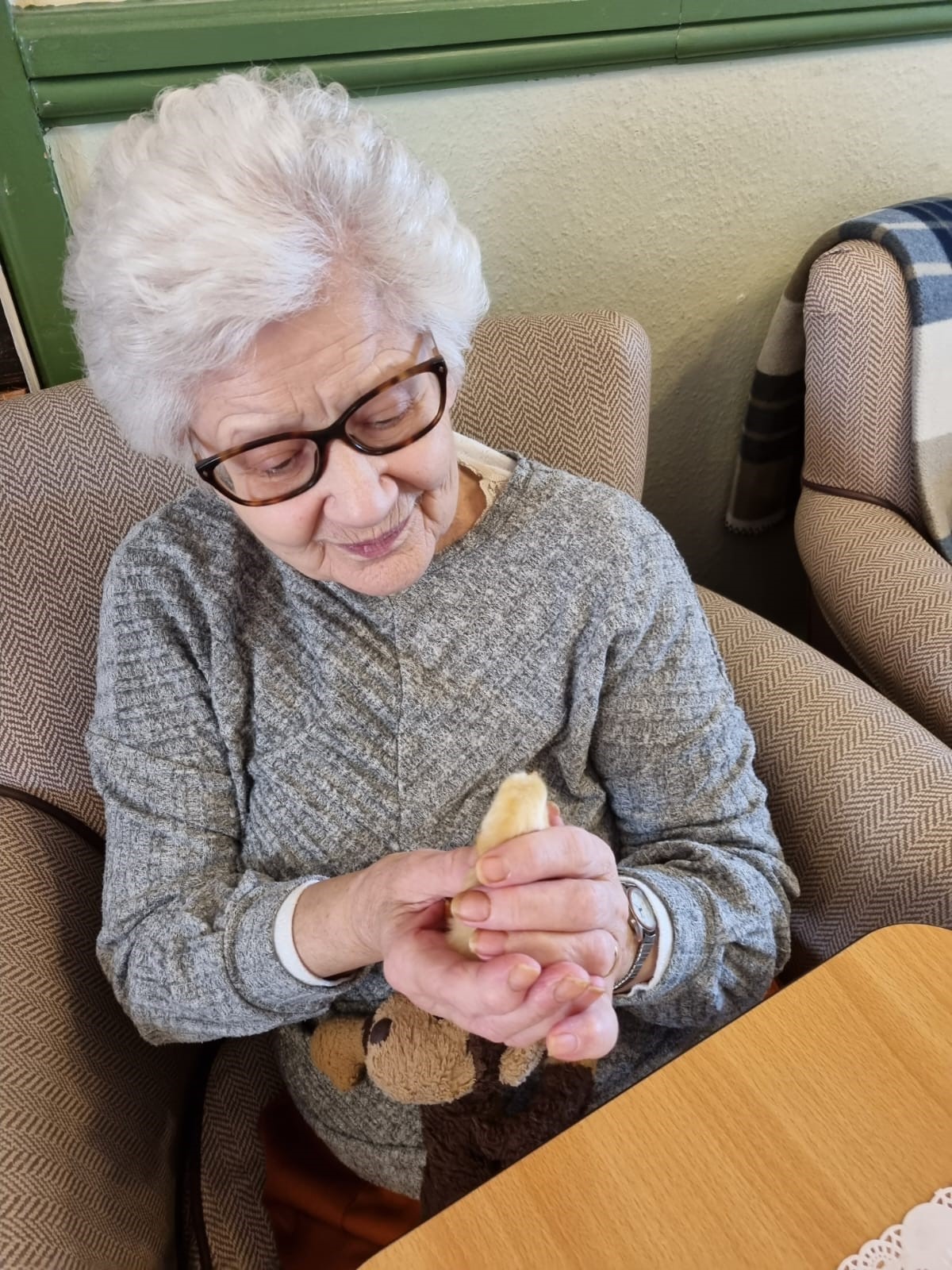 A resident holding one of the chicks (Doveleigh Care)