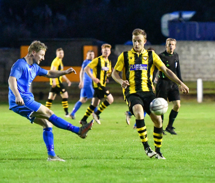 Scott Kellow challenges for the ball. Falmouth Town FC.