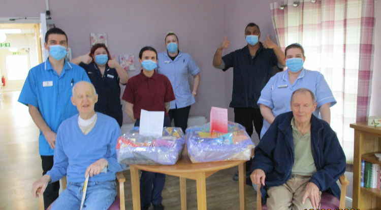 Staff and residents with the hampers from Maisie Button