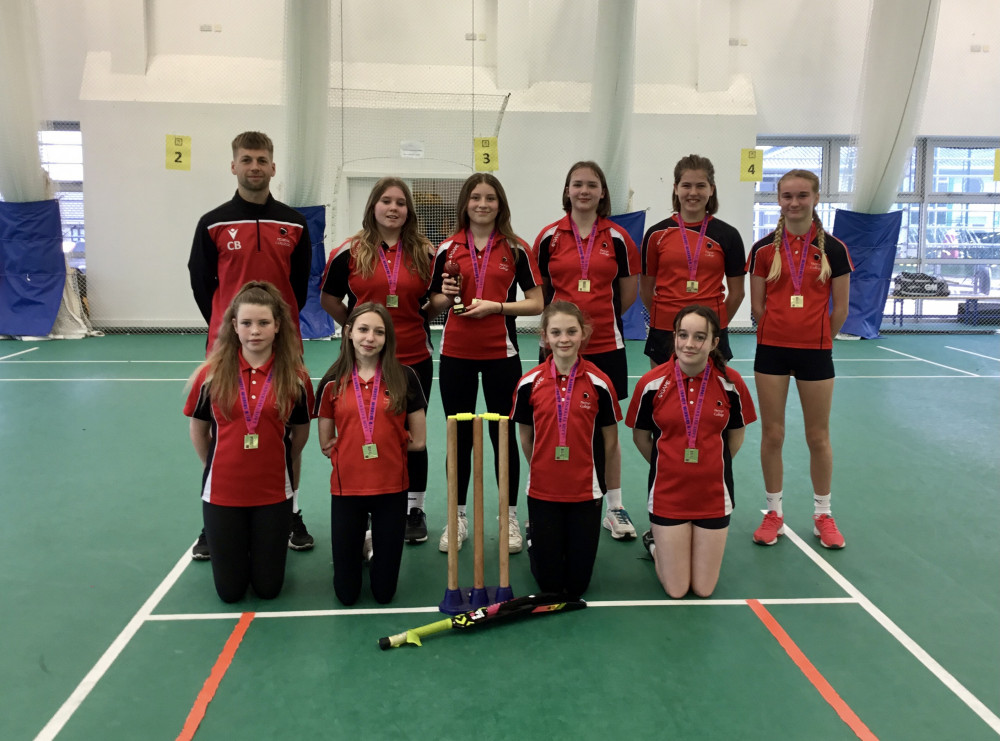 U13 girl's cricket team with the county trophy. 