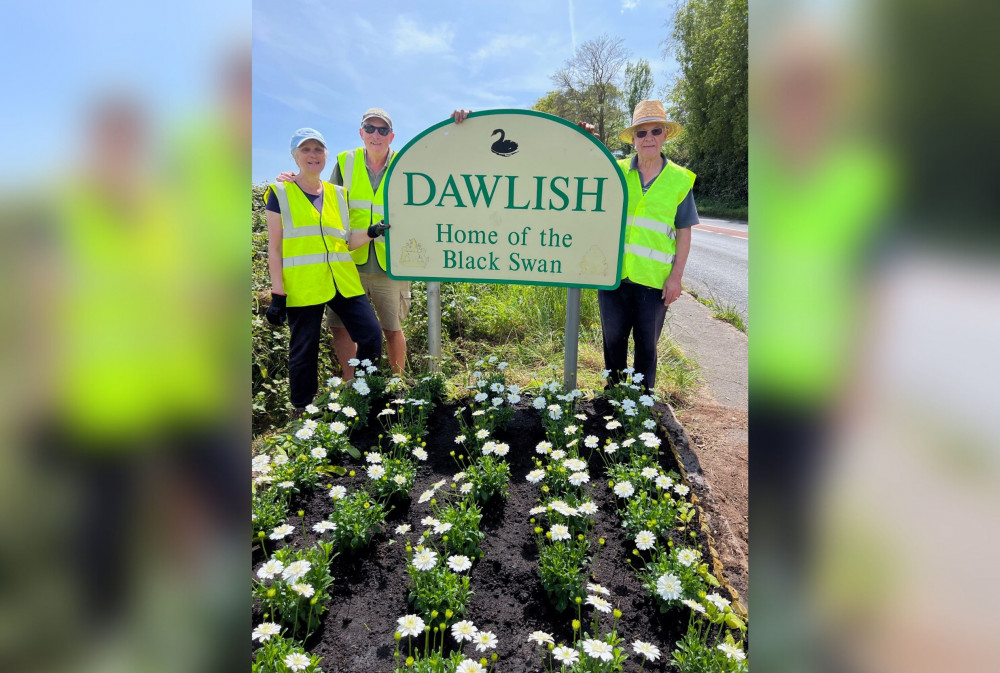 Members Steve and Karen Templeman, Roger Kohl, and June Cassidy cleared up and replanted the flowerbed beneath the sign (Dawlish Garden Society)