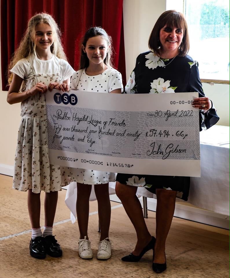 Ray's great great great niece Molly (left) with one of the cheques