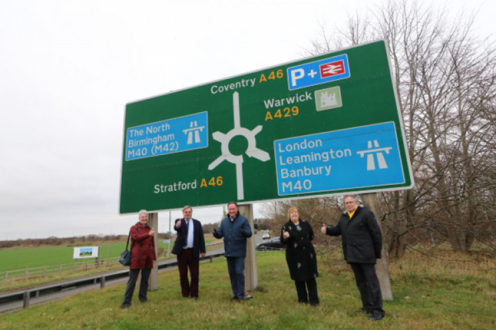 Council leaders posed for a photo op at the Longbridge Roundabout after submitting the request to government in December