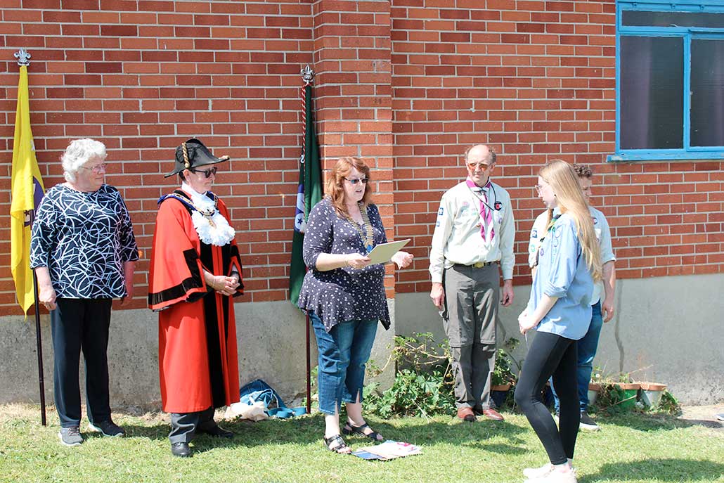 Axminster & District Lions Club president Beverly Love congratulates Kate Somers on receiving the club's gold award