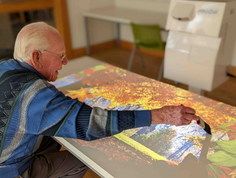 Photo of man using OMI Interactive Projector