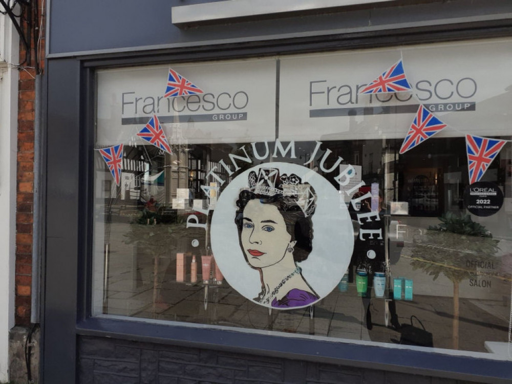 Francesco salon owner, Mike Fenton, in front of his window.