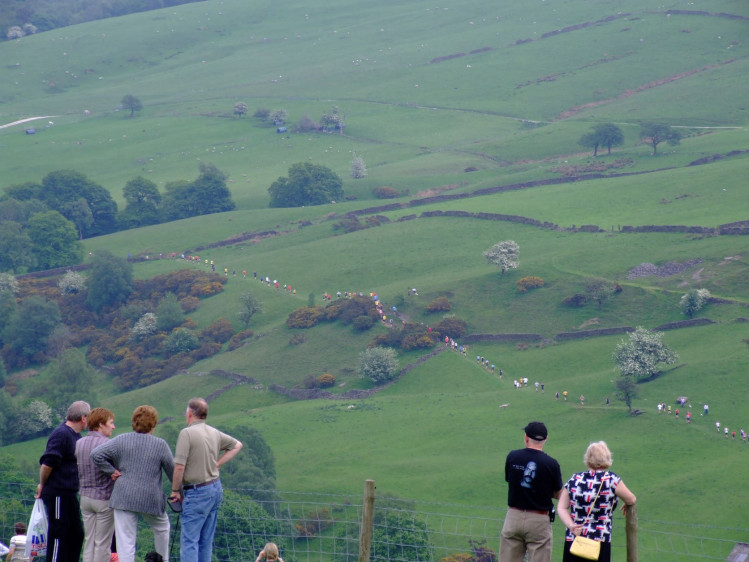 People look on as entrants take part in the Wincle Trout Run at a previous year’s Wincle Fete.