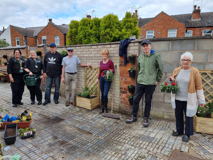 Smiling Crewe residents with the support team after a recent alleyway clean-up session (Cheshire East Council).