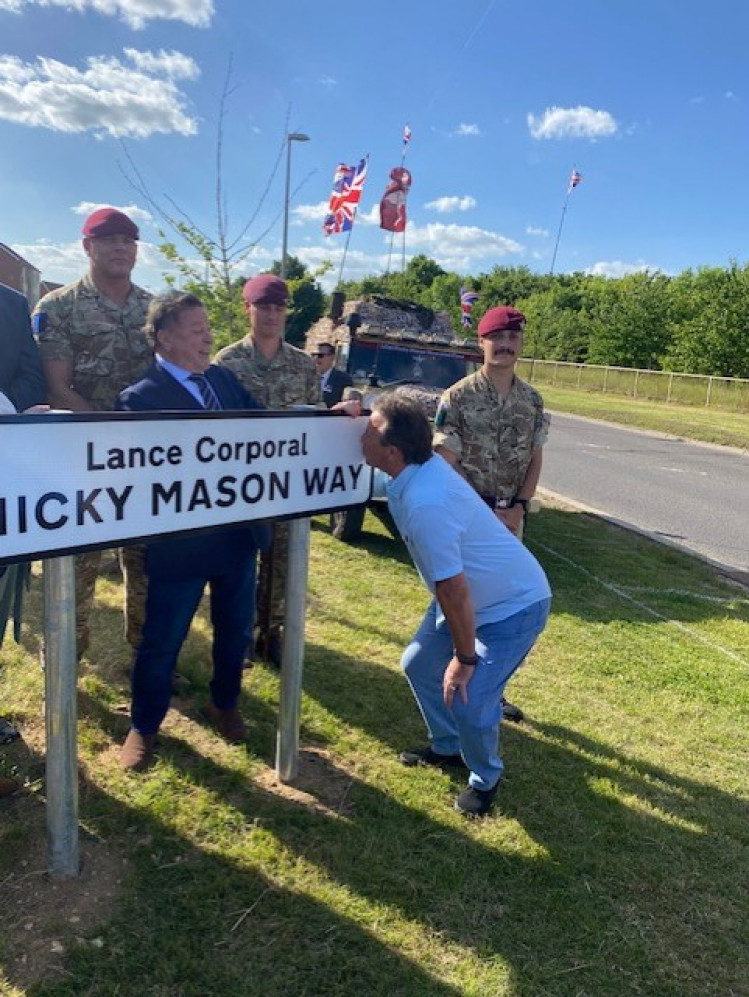 At last! Dennis Mason kisses the sign honouring his son.