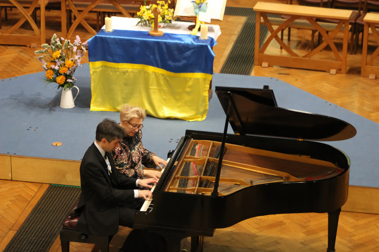 Ivan, pictured playing the piano with his mother Luba, after the last Macclesfield concert. (Image - Alexander Greensmith / Macclesfield Nub News)