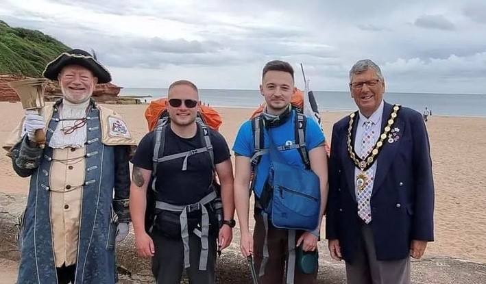 Ryan pictured with the mayor and town crier of Exmouth as he starts his walk