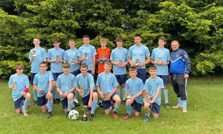 Picture: all the players with their cup and individual trophies and their coach Adam Bean. 