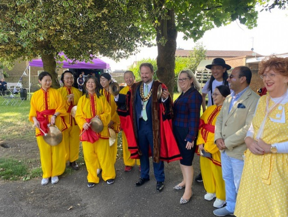 Mayor James Halden, MP Jackie Doyle-Price and Communities portfolio holder Cllr Qaisar Abbas in Grays Town Park with some of the entertainers. 