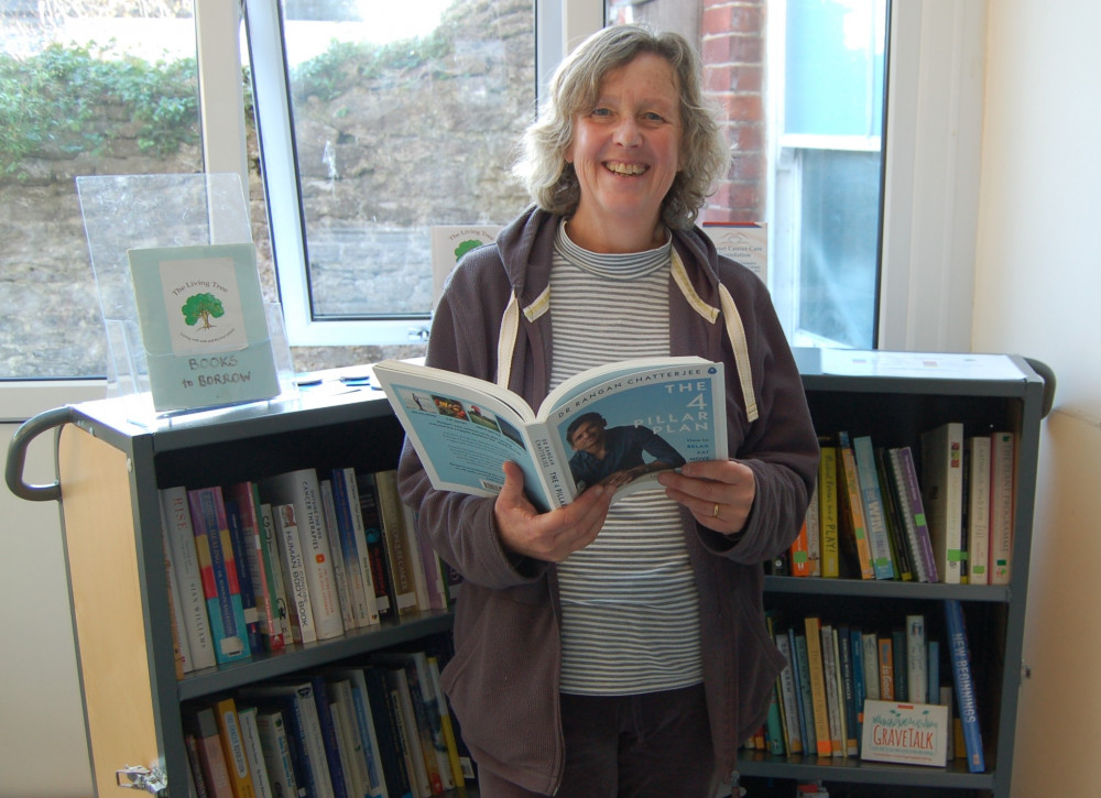 Our out-going admin assistant, Rose Thorpe, browsing the books in the Living Tree library.