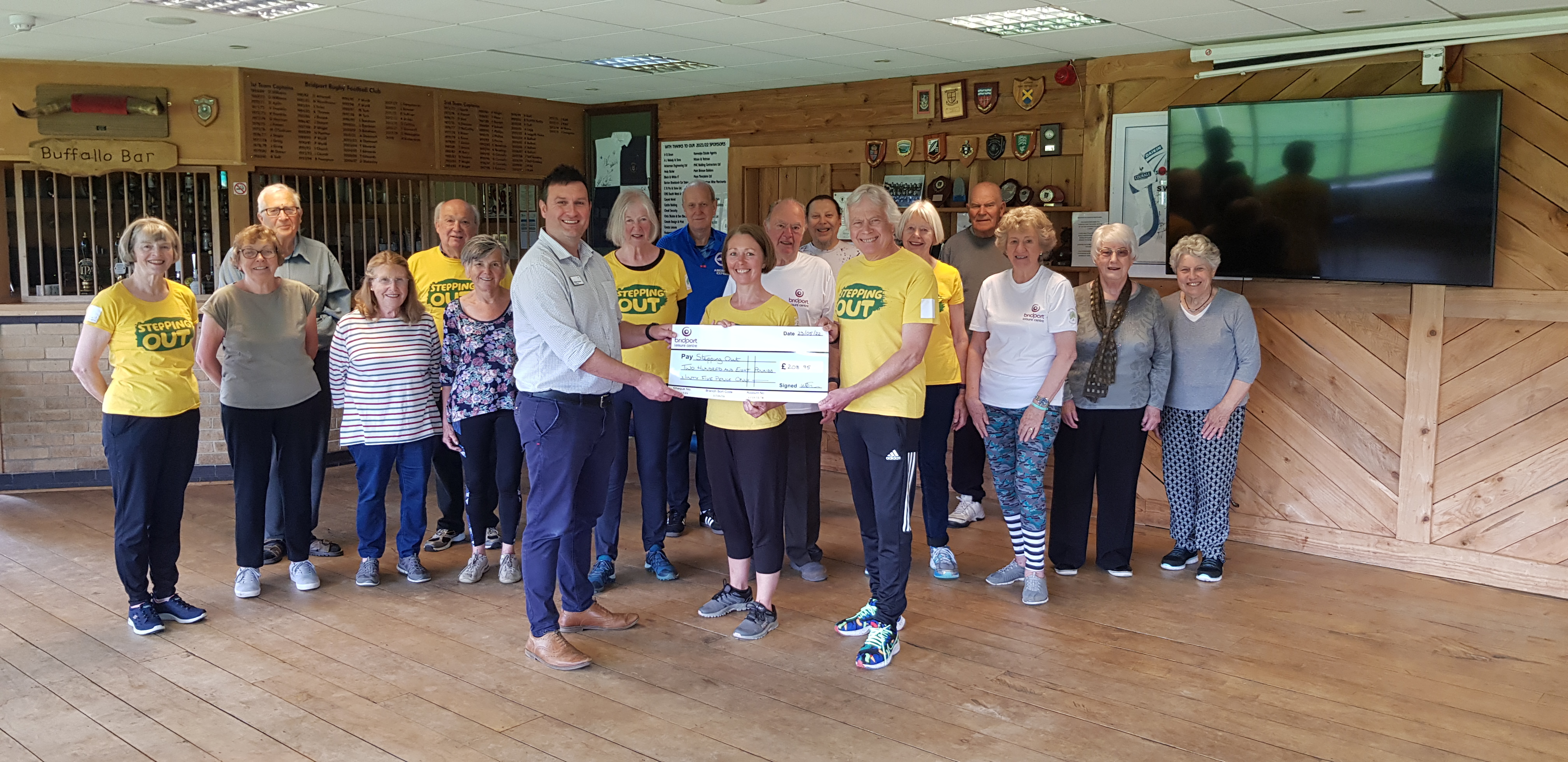 Stepping Out receiving its cheque from Bridport Leisure Centre manager William Thrower