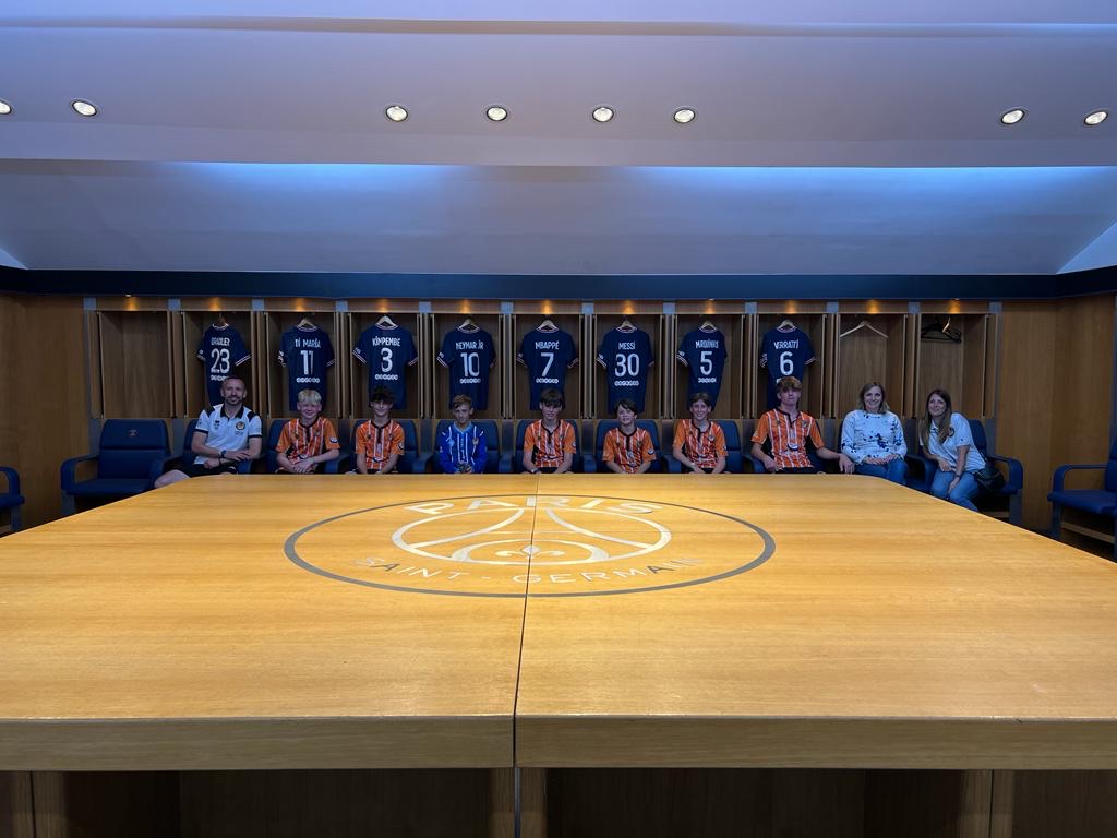 Visiting the dressing rooms with some star shirts on display