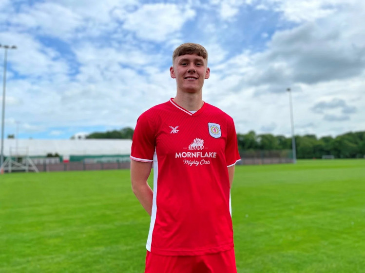 Connor O'Riordan celebrating his new three-year contract in Crewe Alex's new home shirt (Crewe Alex).