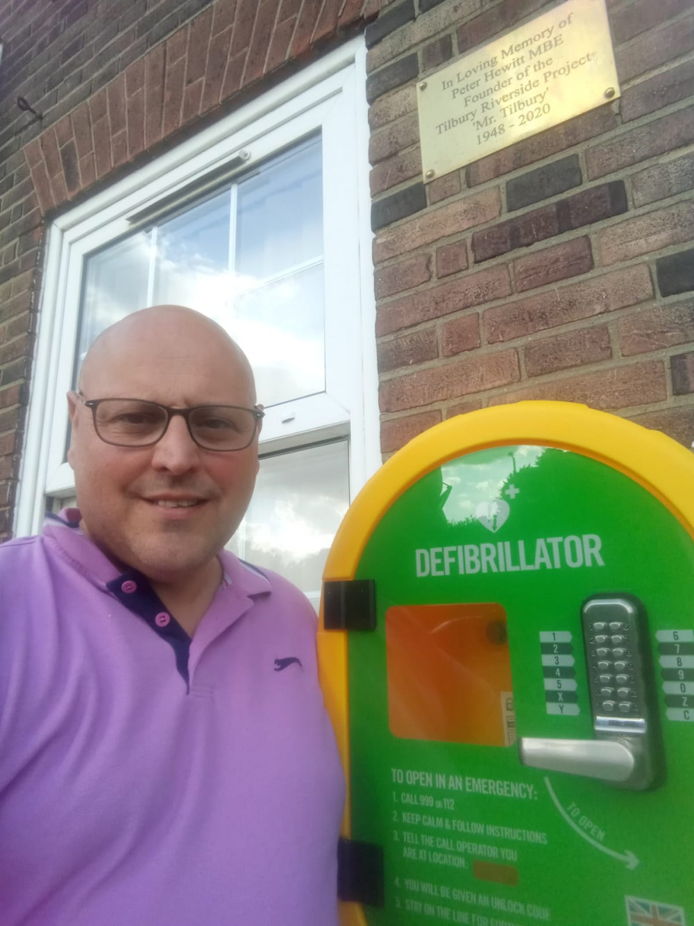 Cllr John allen with the defibrillator cabinet at the Civic Hib. 